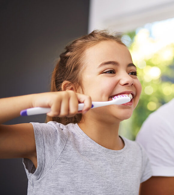 father and daughter brushing teeth